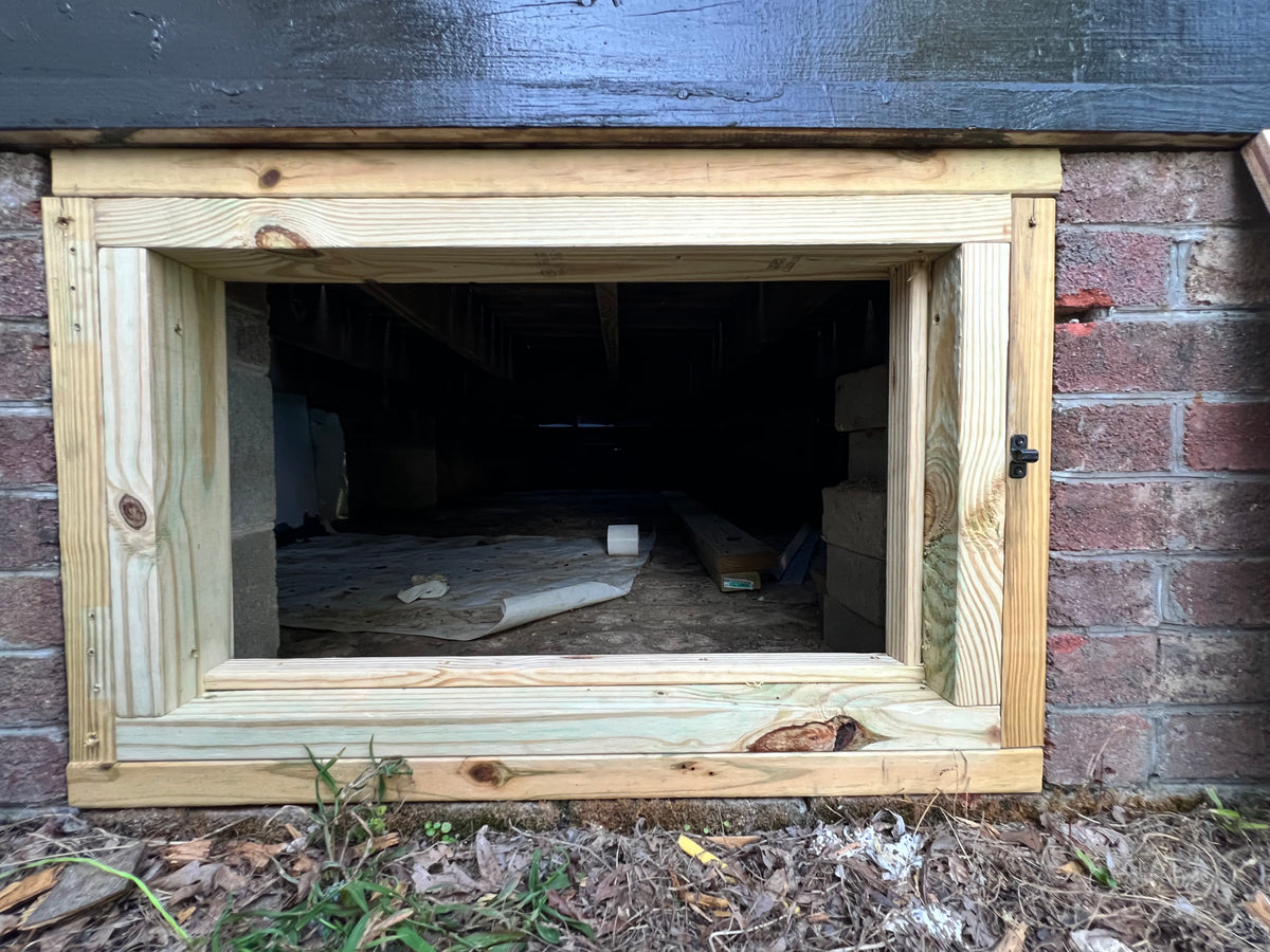 Custom crawl-space access door shown open