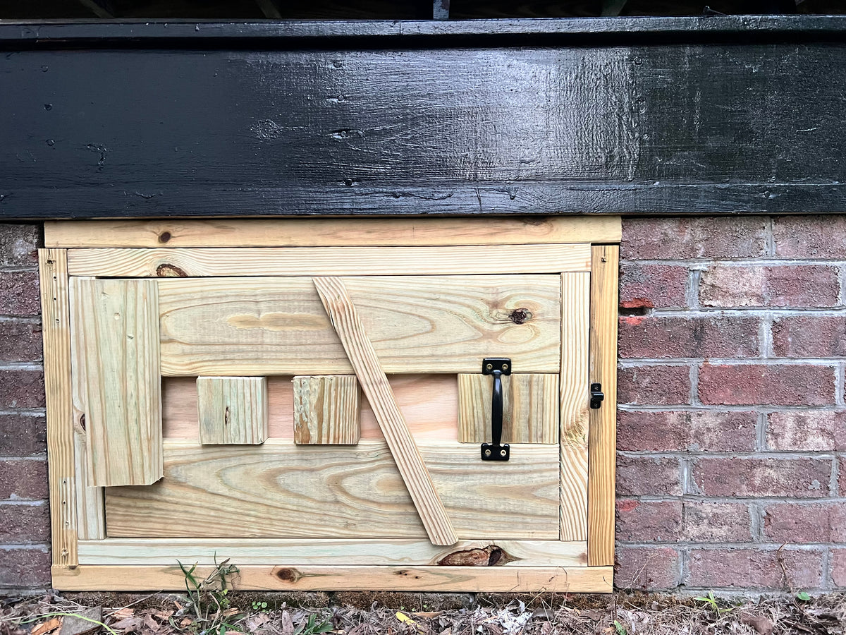 Completed custom crawl-space door, straight-on view